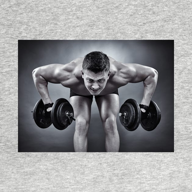 Athletic man working with heavy dumbbells by naturalis